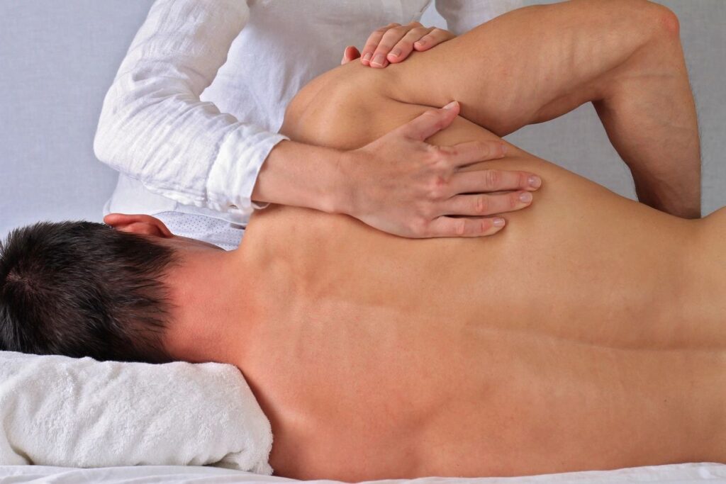 Man receiving an adjustment from a Chiropractor